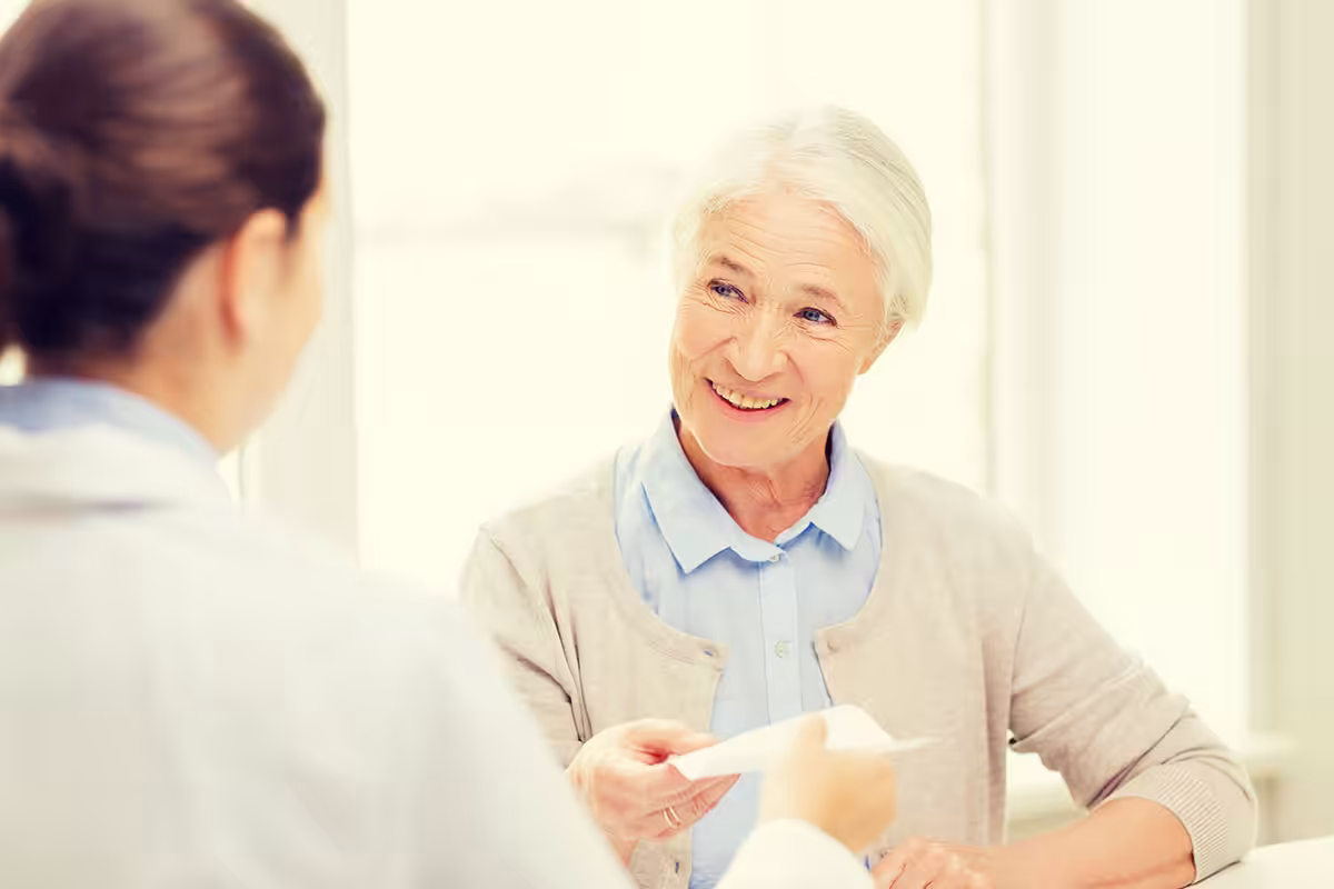 Retiree reviewing life-sustaining medication exceptions with healthcare provider for ASEBP drug coverage
