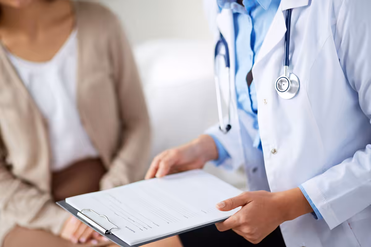 Retired educator and doctor completing special authorization drug coverage form for MyRetiree Plan benefits