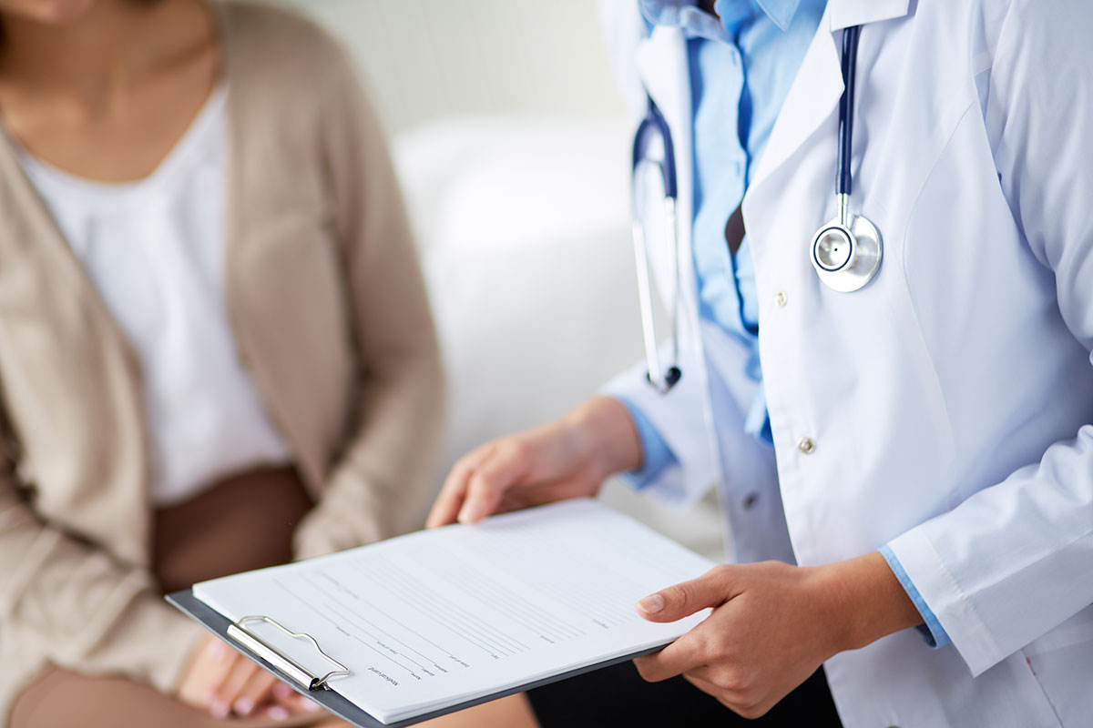 Retired educator and doctor completing special authorization drug coverage form for MyRetiree Plan benefits